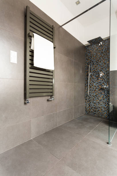 istock Dark bathroom with glass shower 823874448