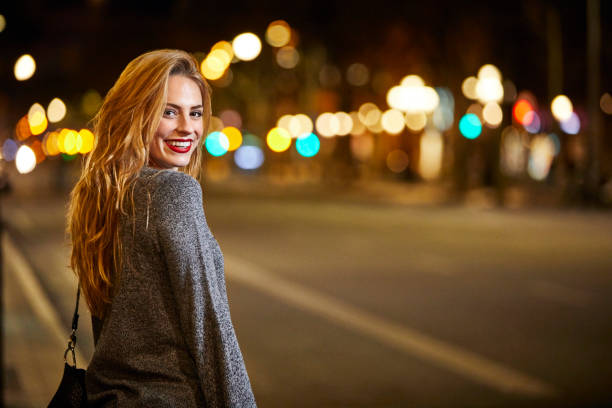 istock Smiling woman looking over shoulder in city 823876830