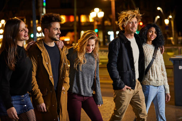 istock Multi-ethnic friends walking on sidewalk in city 823876954