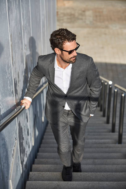 istock Full length of businessman walking on steps 823885814