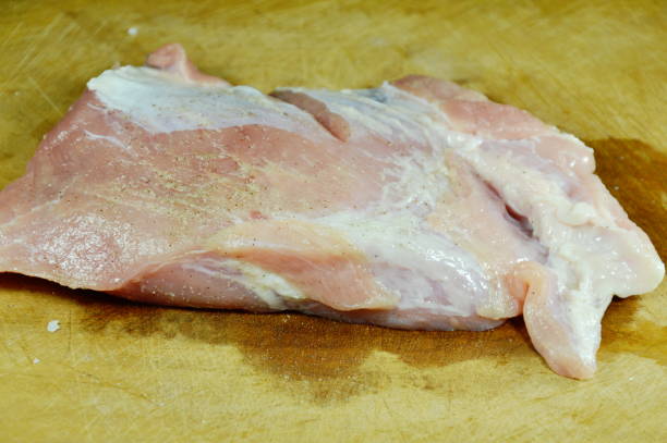 istock raw pork tenderloin marinated with salt and pepper 823886364