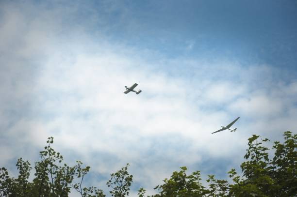 istock a glider hauled by plane against blue sky 823890186
