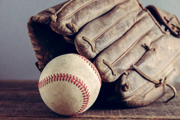 istock old Baseball and glove on wood background with filter effect retro vintage style 823890188