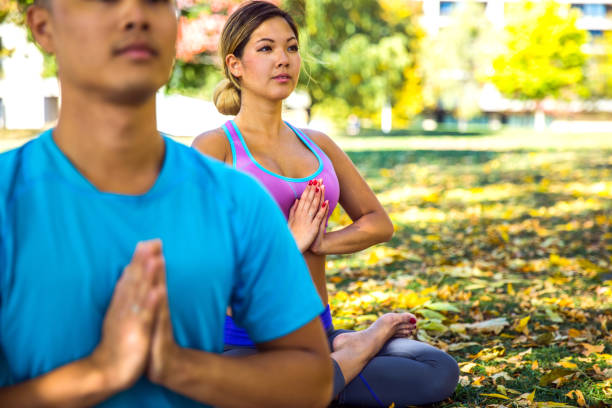 istock Chinese couple having yoga class outdoor 823891462
