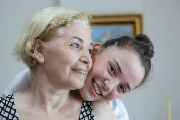 istock Smiling young daughter embracing her mother behind 823898506