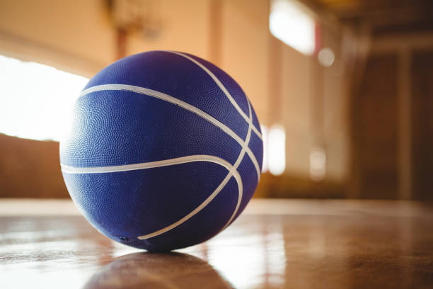 istock Blue basketball on hardwood floor 823902042