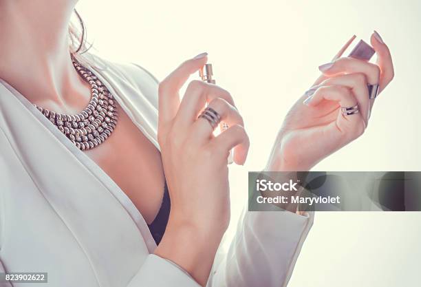 Woman Applying Perfume On Her Wrist Stock Photo - Download Image Now - Perfume, Women, Applying