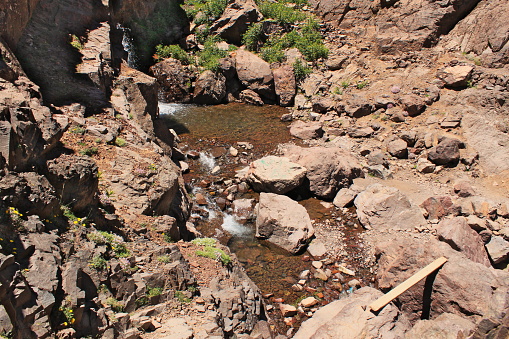 Small waterfall in Atlas mountains in Morocco. Trekking on Toubkal - the highest peak in Morocco,