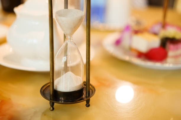 istock Retro hourglass on wood table in tea time 823912996