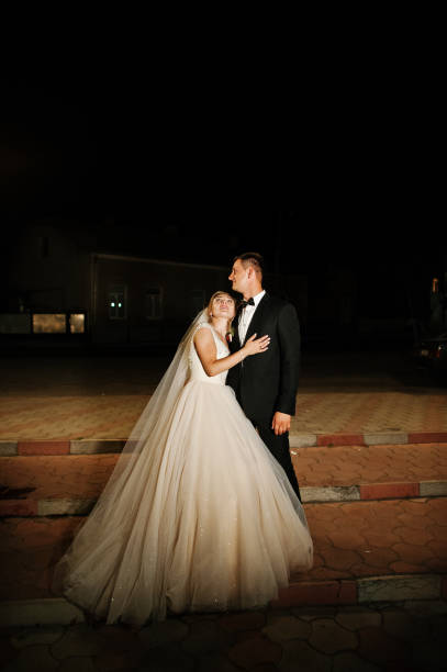 istock Fabulous wedding couple posing outdoor at night. 823913872