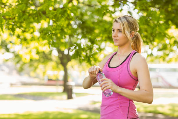istock Fit blonde opening her water bottle 823916850