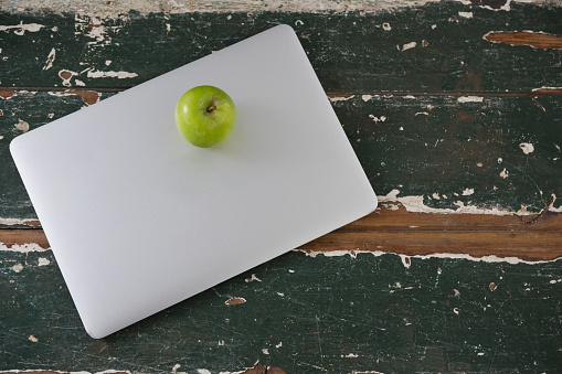 Close-up of apple kept on laptop