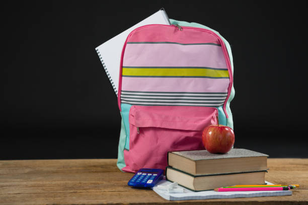 istock Apple on stack of books with calculator and school bag 823920728