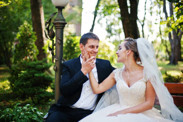 istock Fantastic wedding couple walking in the park on their wedding day. 823920898