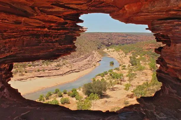Karijini National Park is located in west part of Australia. Beautiful view on canyon with river through the natural window in rock.