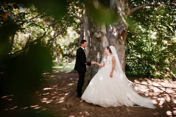 istock Absolutely stunning young wedding couple walking and posing in the forest. 823927836