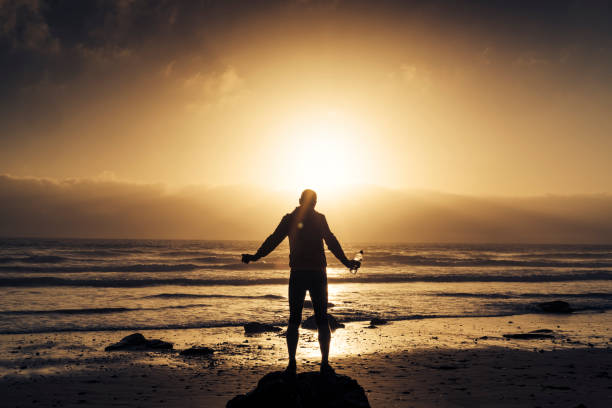 istock Man Pre run stretching near sunset on the beach. 823932290