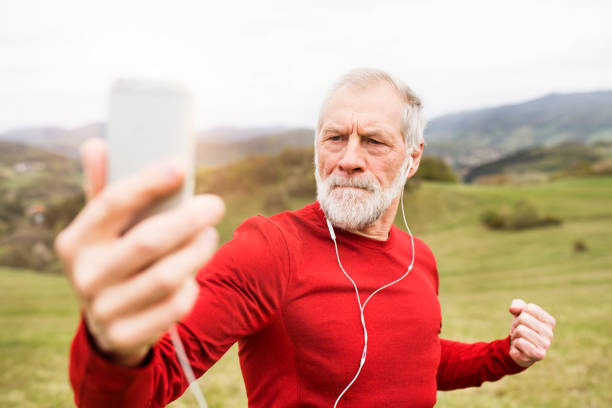 istock Active senior runner in nature taking selfie with smart phone. 823945894