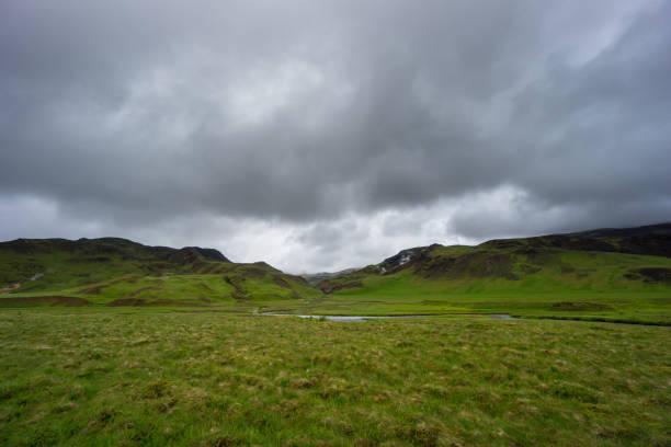 istock Iceland - River flowing between green volcanic mountains 823950282