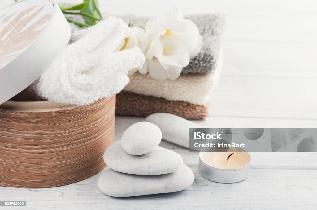 Set of bathroom accessory on wooden background Set of bathroom accessory on wooden background: pebbles, towels, candle Box - Container Stock Photo