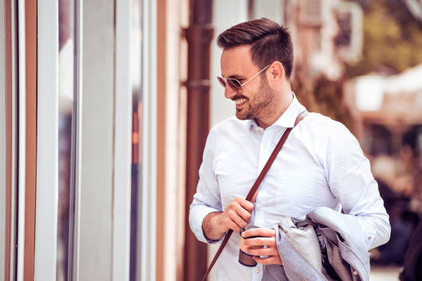 istock Young handsome businessman with cup of coffee 823963272