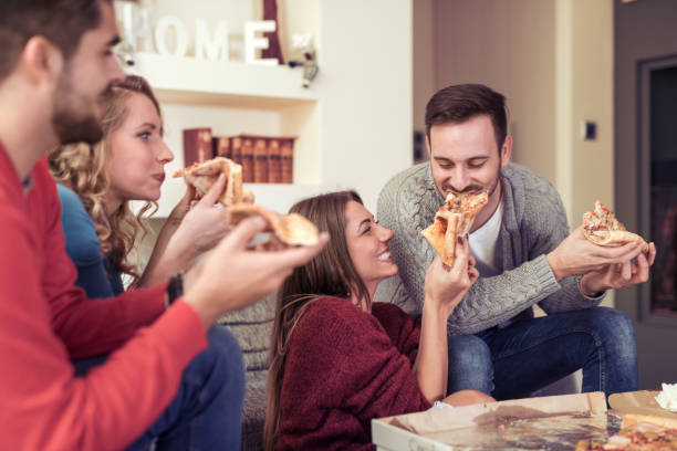 istock Friends talking and eating pizza 823973580