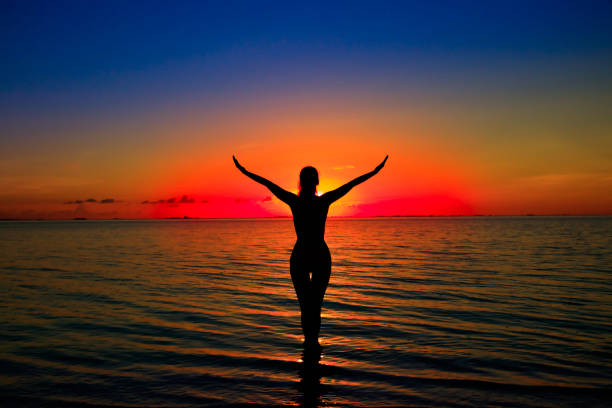 istock Woman silhouette on water 823975134