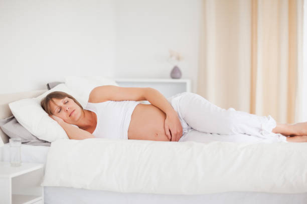 istock Beautiful pregnant woman relaxing while lying on her bed 823978082
