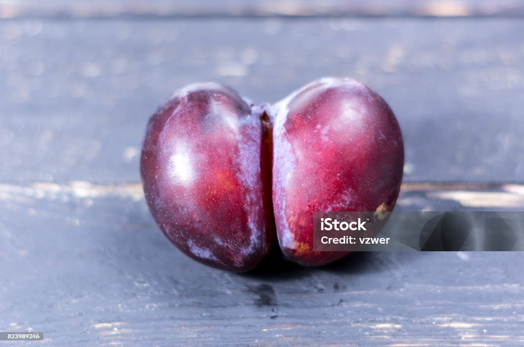 Unique and not ordinary plum. Plum in the form of an ass. Unique and not ordinary plum. Plum in the form of an ass. Unique plum. Breast Stock Photo