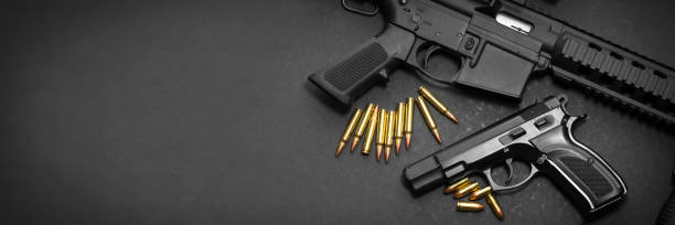 Handgun and rifle 9mm handgun with ar15 rifle and ammunition on dark background with copy space gun stock pictures, royalty-free photos & images