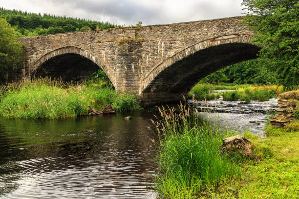 istock Old stone bridge over river Dee, Wales 823992538