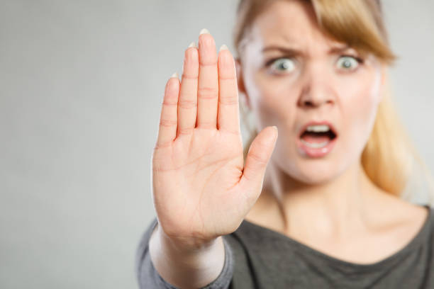 istock Female shows stop sign by her hand. 824001814