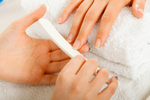 istock Woman getting manicure done file nails 824010116