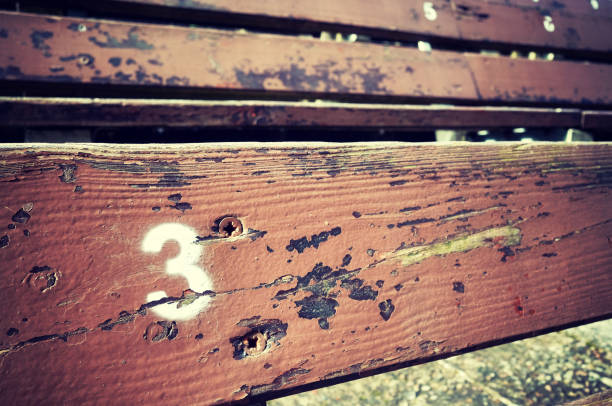 Wooden bench next to old church wall in Scicli, Sicily, Italy.