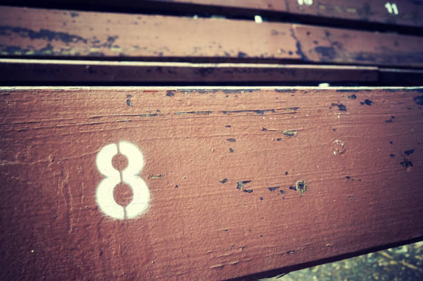 istock Number eight painted on an old wooden seat. 824017498