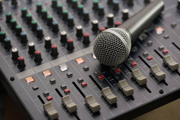 istock Microphone put on the Professional Music Mixer Console with dial knob and slide bar. 824017760