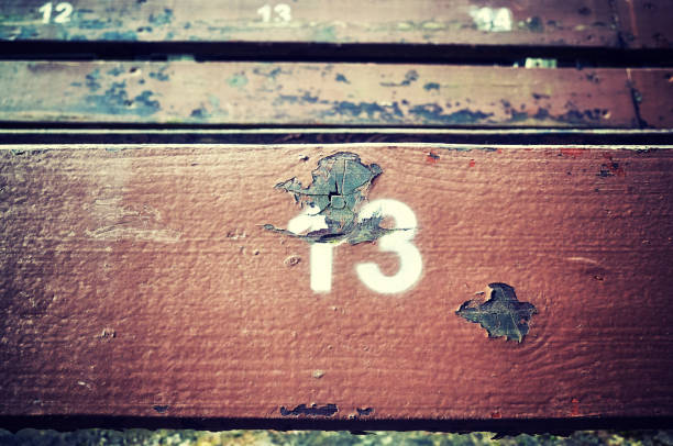 istock Number thirteen painted on an old wooden seat. 824017764