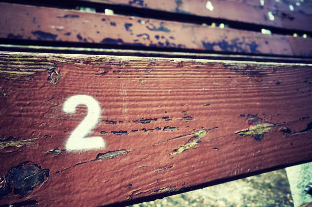 istock Number two painted on an old wooden seat. 824017832