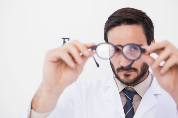 istock Doctor wearing lab coat looking through eyeglasses 824027518