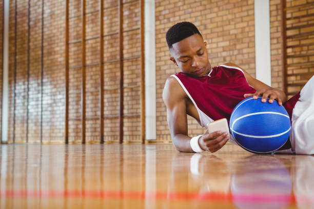 istock Male basketball player using mobile phone 824030674