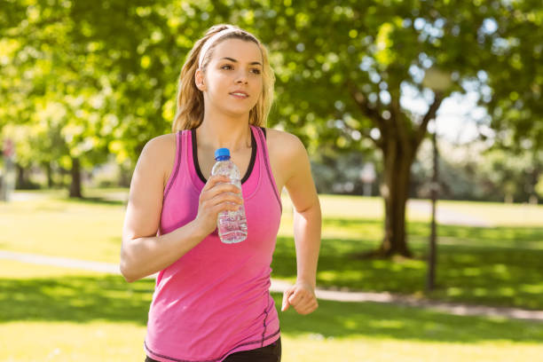 istock Fit blonde jogging in the park 824033130