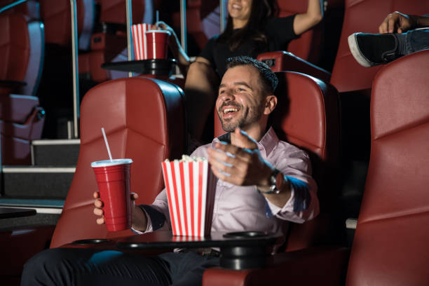 istock Attractive guy watching a comedy film 824033394