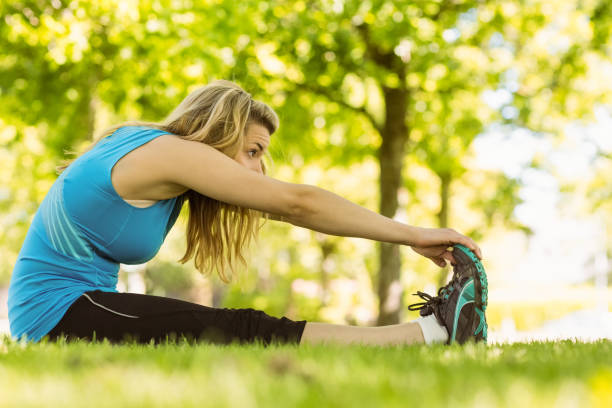 istock Fit blonde stretching in the park 824033828