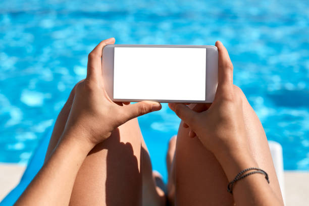istock Woman using mobile phone by the pool 824037348