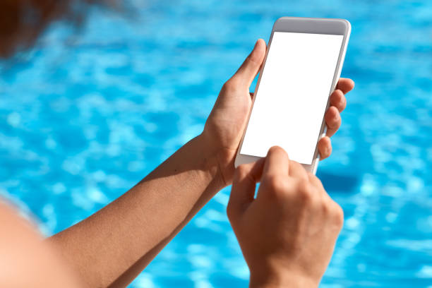 istock Woman using mobile phone by the pool 824037368