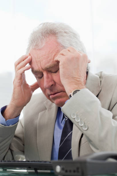 istock Portrait of an exhausted senior manager having a headache 824037594