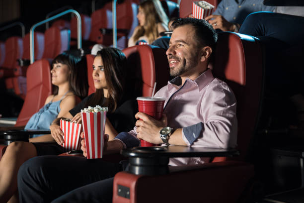 istock People watching a movie and eating popcorn 824037598