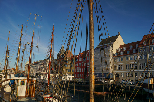 Copenhagen, Denmark - June 17, 2017: The famous Nyhavn canal in Copenhagen Denmark in the late afternoon.  The canal is lined with restaurants which overflow with patrons each evening.