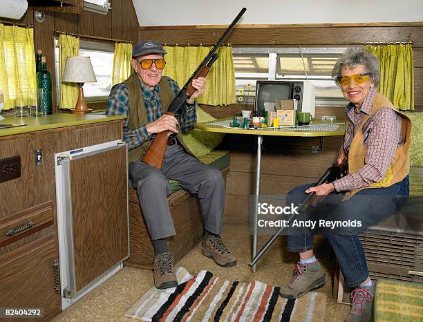 Man And Woman With Guns Stock Photo - Download Image Now - Gun, Cleaning, Senior Couple
