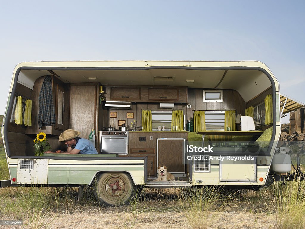 man trimming flower in trailer  Motor Home Stock Photo